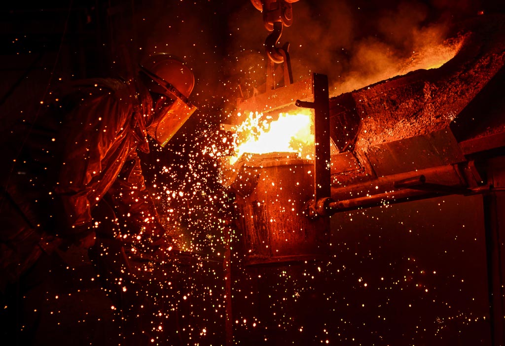 PRCO America person working with molten metal that is sparking